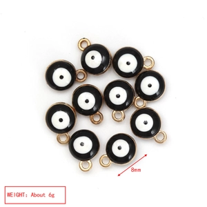 Detail showing 8mm golden evil eye charms for jewelry making with precise measurements
