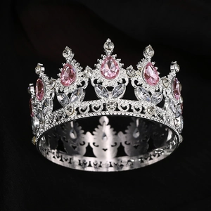 Detail of silver crown with pink teardrop gemstones and intricate floral engravings