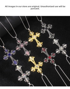 Close-up of baroque hollow cross pendants with colorful rhinestones on black background