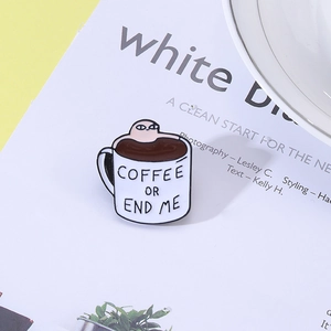 Detail of coffee cup enamel pin featuring cartoon figure and humorous text