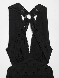 Detail of black eyelet embroidery dress with halter neck and silver ring connector