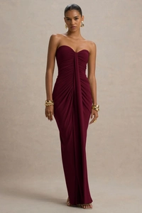 Detail of elegant burgundy strapless evening dress featuring pleated knot and ribbon drape