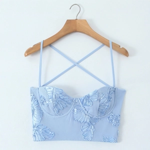 Light blue halter neck crop top with 3D floral embroidery and criss-cross straps
