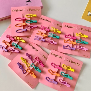 Set of colorful macaron mini hair clips in various shapes like hearts and bows on card
