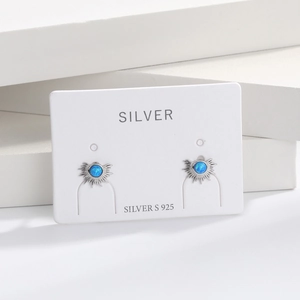 Macro shot of S925 sterling silver sunburst stud earrings with blue opal stone inlay