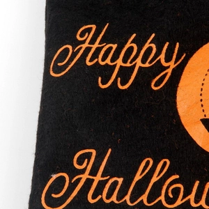 Detail of Happy Halloween print on felt fabric with pumpkin design and fine texture