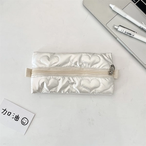 Detail of heart-quilted PU leather pencil case with metallic finish and top zipper