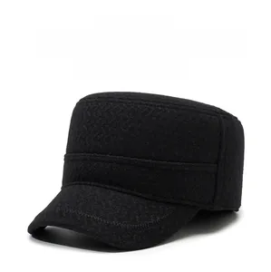 Close-up of a warm winter military hat for elderly men featuring ear flaps and metal logo
