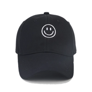 Classic black cotton baseball cap with white smiley face embroidery on a curved brim hat