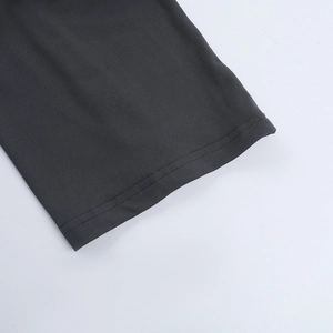 Detail of dark gray ribbed knit fabric showing high-quality stitching and texture