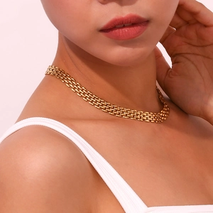 Detailed close-up of 18K gold plated woven mesh necklace with watchband style texture
