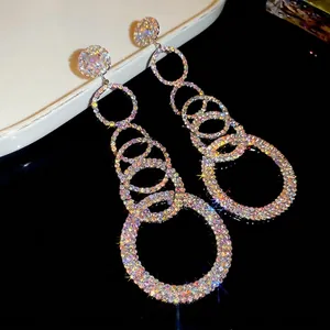 Glamorous silver needle earrings with shimmering rhinestone circles and tassel drop design