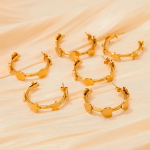 Golden C-shaped stainless steel earrings set with star and heart charms on satin
