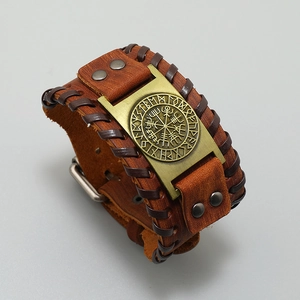 Detail of Viking compass engraving on brown woven leather bracelet with bronze metal plate