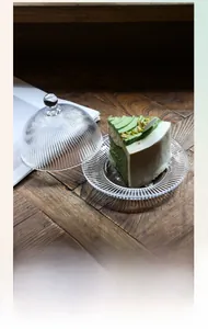 Detail of clear ribbed glass dome cover and thick dessert tray for home snack display