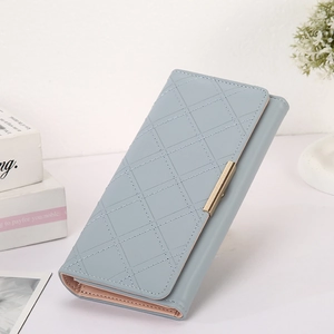 Close-up of light blue long wallet with diamond quilted stitching and metallic trim
