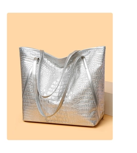 Detail of silver crocodile pattern tote bag with high-quality leather texture and dual straps