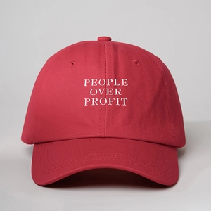 Classic red cotton baseball cap with white PEOPLE OVER PROFIT embroidery and curved brim