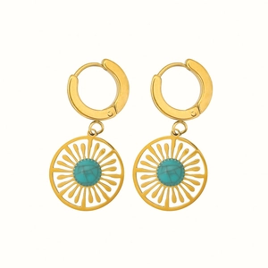 Vintage hollow sunburst earrings in gold finish featuring round turquoise center stones