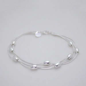 Macro shot of 925 sterling silver stamp on multilayer bead bracelet with silver finish