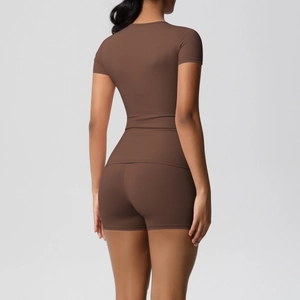 Back view of brown skin-friendly yoga set showing slim fit short sleeve top and shorts