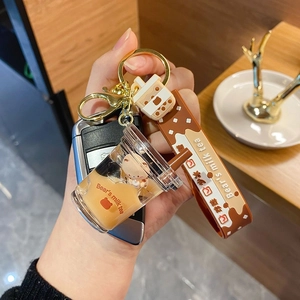 Creative bubble tea keychain with liquid bear charm and brown silicone hand strap