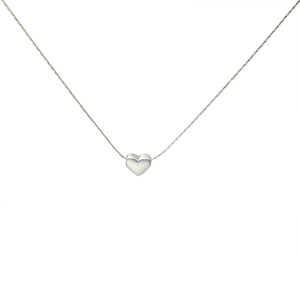 Detailed view of silver heart pendant with fine snake chain in matte metallic finish