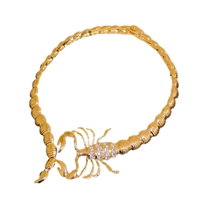 Exaggerated golden scorpion choker necklace with rhinestones in minimalist metal design