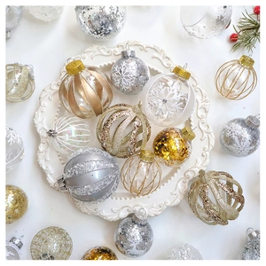Detail of Christmas tree ornaments with gold and silver glitter in a ceramic tray