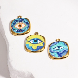 Detailed macro of golden square evil eye pendants with colorful enamel oil painting finish