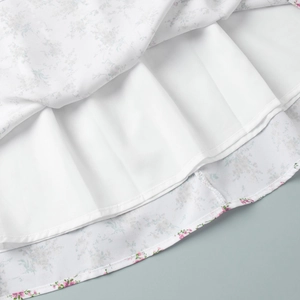 Detail of floral chiffon dress hemline with white lining and neat hem stitching