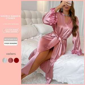 Detailed view of pink silk satin robe with ruffled cuffs and matching waist tie closure