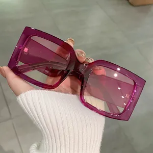 Fashionable oversized square sunglasses with translucent magenta resin frame and purple lens