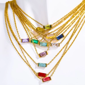 Gold plated stainless steel birthstone necklaces with colorful zircon pendants on display