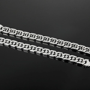 Macro shot of silver punk cross-pattern metal chain links with high polish finish