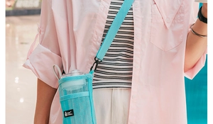 Detail of light blue mesh water bottle sleeve with adjustable strap and brand tag