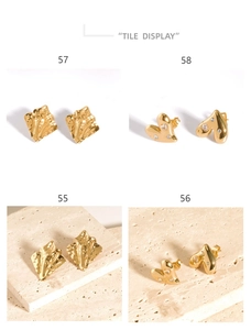 Macro view of 18K gold pleated irregular wave and heart-shaped crystal stud earrings