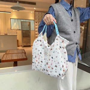 Detailed macro shot of white puffy texture tote bag with blue checkered handles