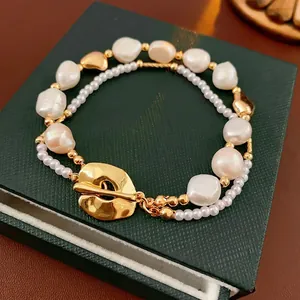 Double-layer freshwater pearl bracelet with gold OT buckle on dark green leather