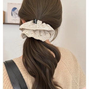 Knit scrunchie in beige with delicate hollow out crochet texture on high ponytail