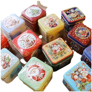 Christmas square tin boxes with festive Santa and reindeer illustrations in various colors