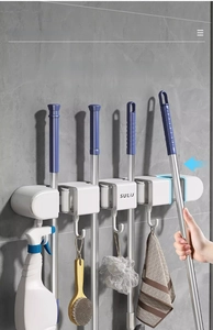 Detail of wall-mounted mop holder with 4 non-slip slots and 5 sturdy hooks