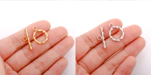 Macro shot of 18k gold and silver stainless steel OT toggle clasps with twisted texture
