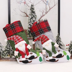 Christmas stockings with gnomes on skis featuring red plaid cuffs and Nordic style