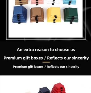 Detailed view of colorful drawer jewelry boxes with textured paper and black ribbon pulls