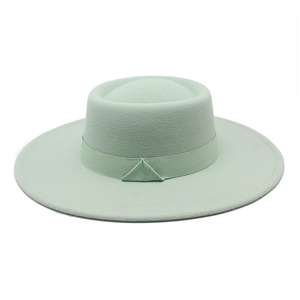 Detail of mint green wool felt boater hat with ribbed ribbon and triangular fold