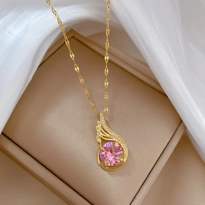 Luxurious phoenix necklace with pink gemstone pendant on silk background in a jewelry box
