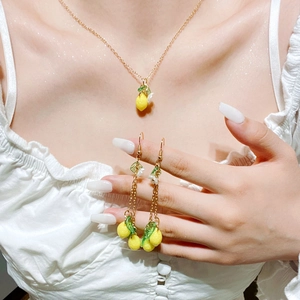 Detail of yellow lemon jewelry set featuring cherry-style necklace and drop earrings