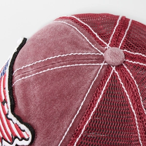 Detail of vintage washed baseball cap showing mesh panels and embroidery stitching