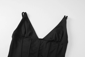 Detail of sexy deep V-neck black corset top with spaghetti straps and boning structure